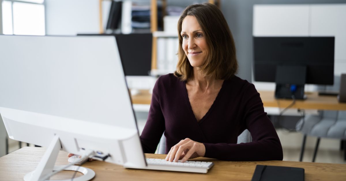 A childcare director sitting at her computer as she pulls tax receipts for parents from the Lillio billing and payments app. 