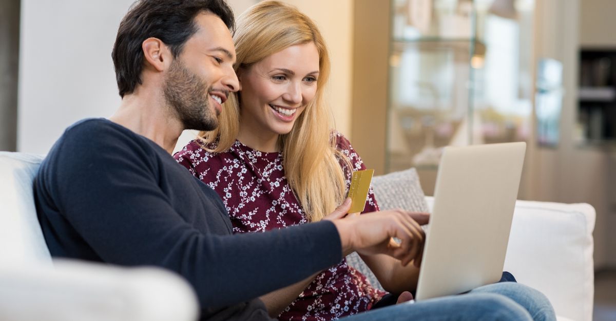 A mom and dad sitting at their computer reviewing the tax receipts that were sent from their childcare. 