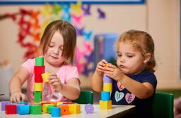 Children building towers with wooden blocks